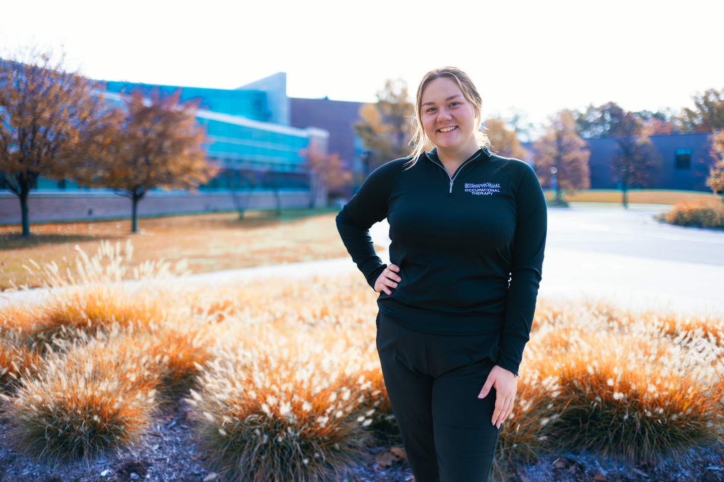 Young woman in field of tan plants